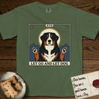 Let Go and Let Dog Bernese Mountain Dog T-Shirt flat lay in Moss, featuring a vintage tarot card with a haloed tricolor Bernese Mountain Dog, paws raised, mountains rising behind her shoulders.