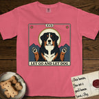 Let Go and Let Dog Bernese Mountain Dog T-Shirt flat lay in Watermelon, featuring a vintage tarot card with a haloed tricolor Bernese Mountain Dog, paws raised, mountains rising behind her shoulders.