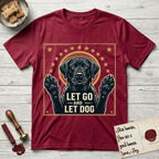 Let Go and Let Dog Black Lab T-Shirt flat lay in Antique Cherry Red, featuring a bold Americana star-badge of a haloed Black Lab with both front paws raised.
