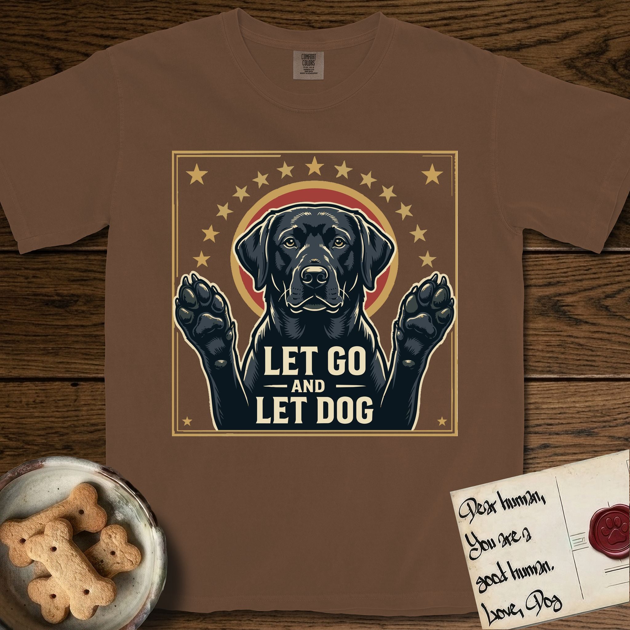 Let Go and Let Dog Black Lab T-Shirt flat lay in Espresso, featuring a bold Americana star-badge of a haloed Black Lab with both front paws raised.