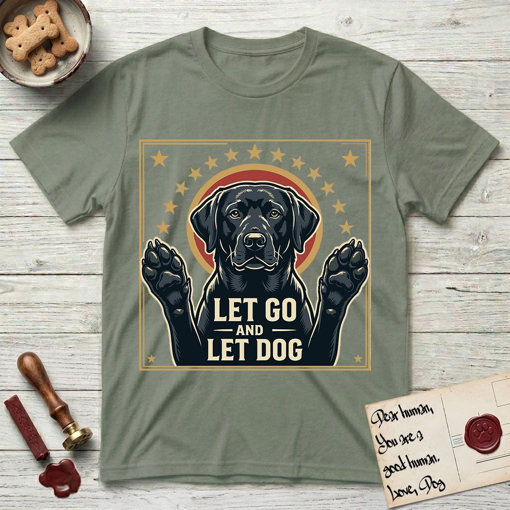 Let Go and Let Dog Black Lab T-Shirt flat lay in Sage, featuring a bold Americana star-badge of a haloed Black Lab with both front paws raised.