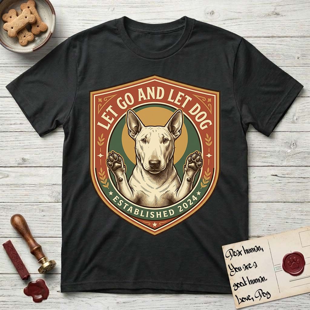 Let Go and Let Dog Bull Terrier T-Shirt flat lay in Black, featuring a vintage badge of a haloed Bull Terrier with paws raised in blessing.