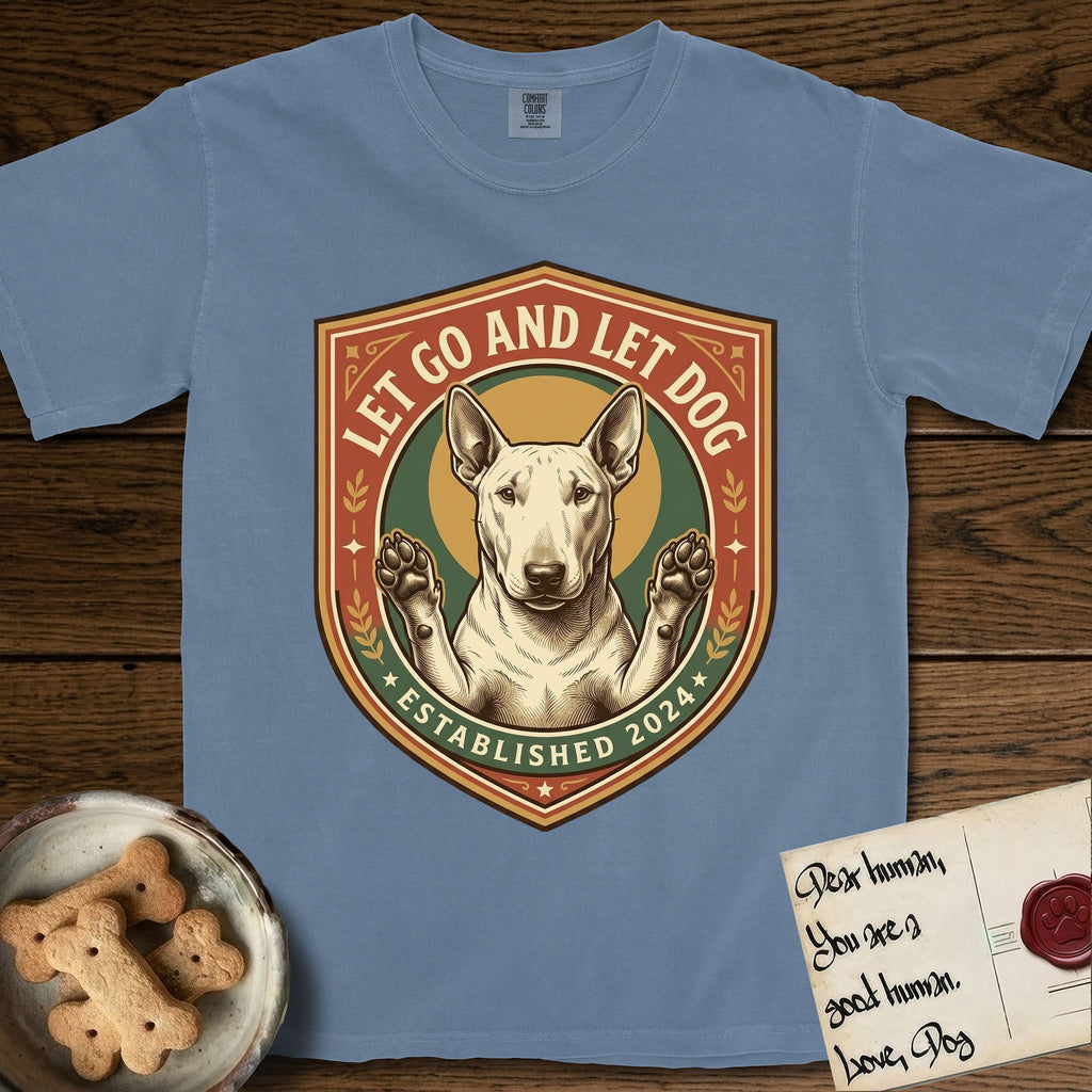 Let Go and Let Dog Bull Terrier T-Shirt flat lay in Blue Jean, featuring a vintage badge of a haloed Bull Terrier with paws raised in blessing.