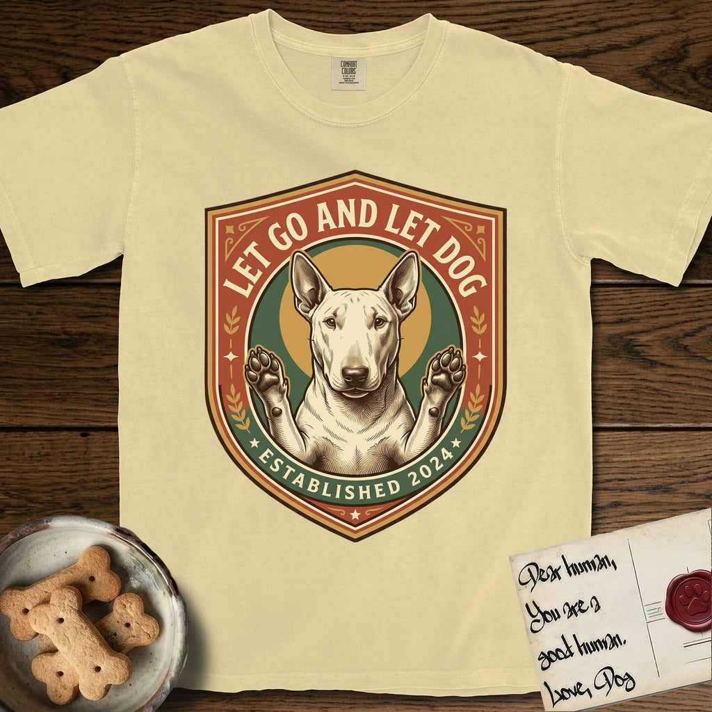 Let Go and Let Dog Bull Terrier T-Shirt flat lay in Butter, featuring a vintage badge of a haloed Bull Terrier with paws raised in blessing.