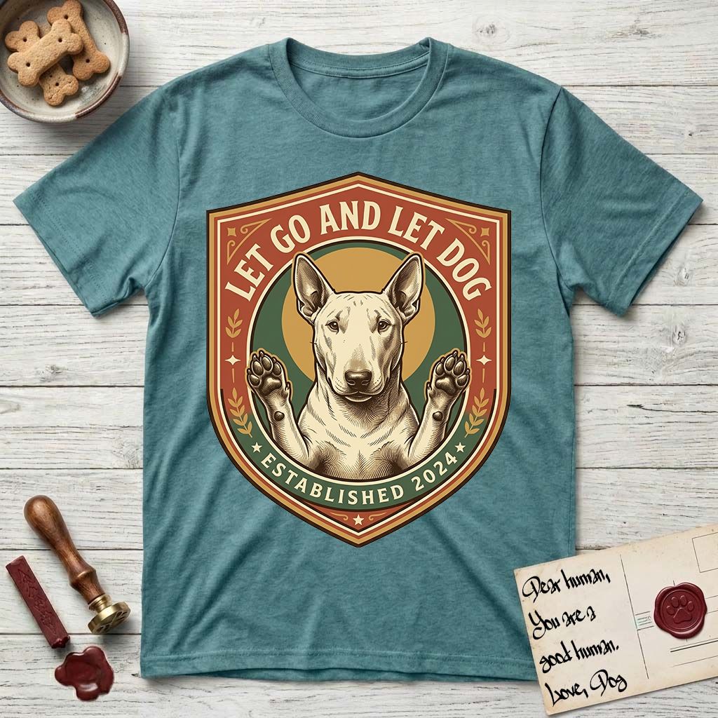 Let Go and Let Dog Bull Terrier T-Shirt flat lay in Heather Galapagos Blue, featuring a vintage badge of a haloed Bull Terrier with paws raised in blessing.