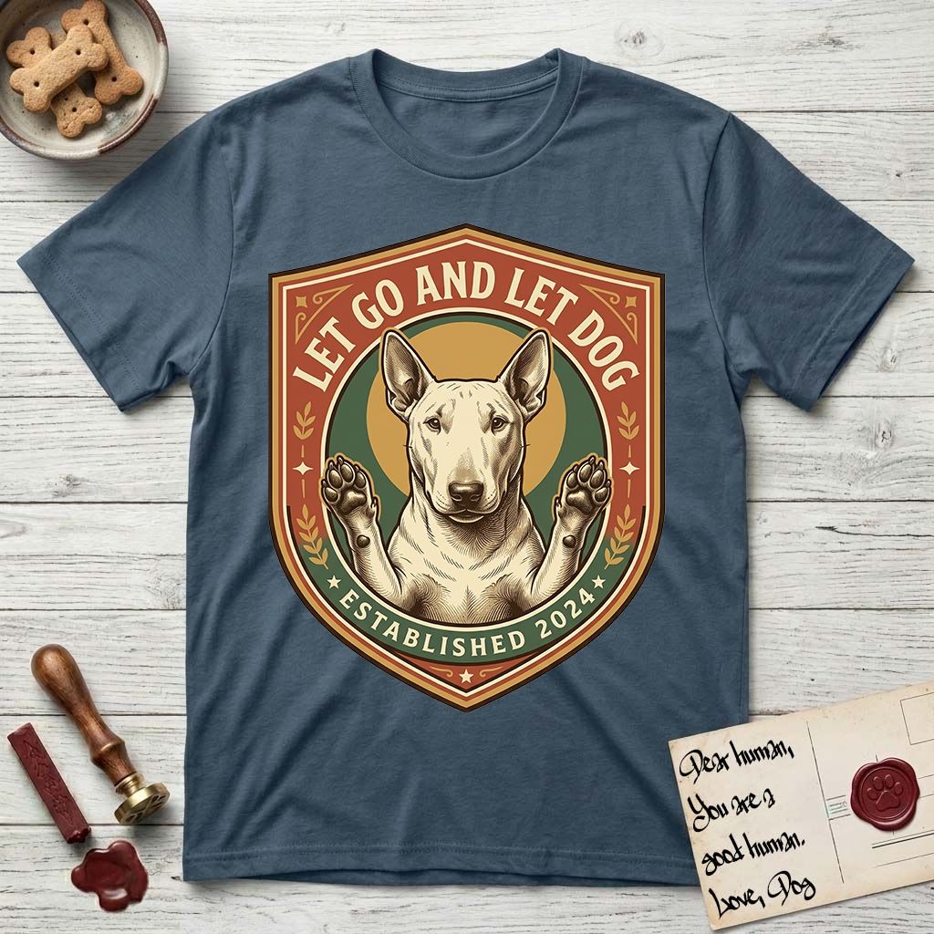 Let Go and Let Dog Bull Terrier T-Shirt flat lay in Indigo Blue, featuring a vintage badge of a haloed Bull Terrier with paws raised in blessing.