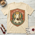 Let Go and Let Dog Bull Terrier T-Shirt flat lay in Natural, featuring a vintage badge of a haloed Bull Terrier with paws raised in blessing.