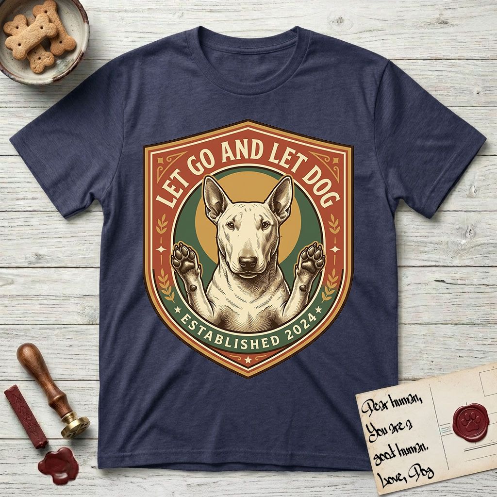 Let Go and Let Dog Bull Terrier T-Shirt flat lay in Navy, featuring a vintage badge of a haloed Bull Terrier with paws raised in blessing.