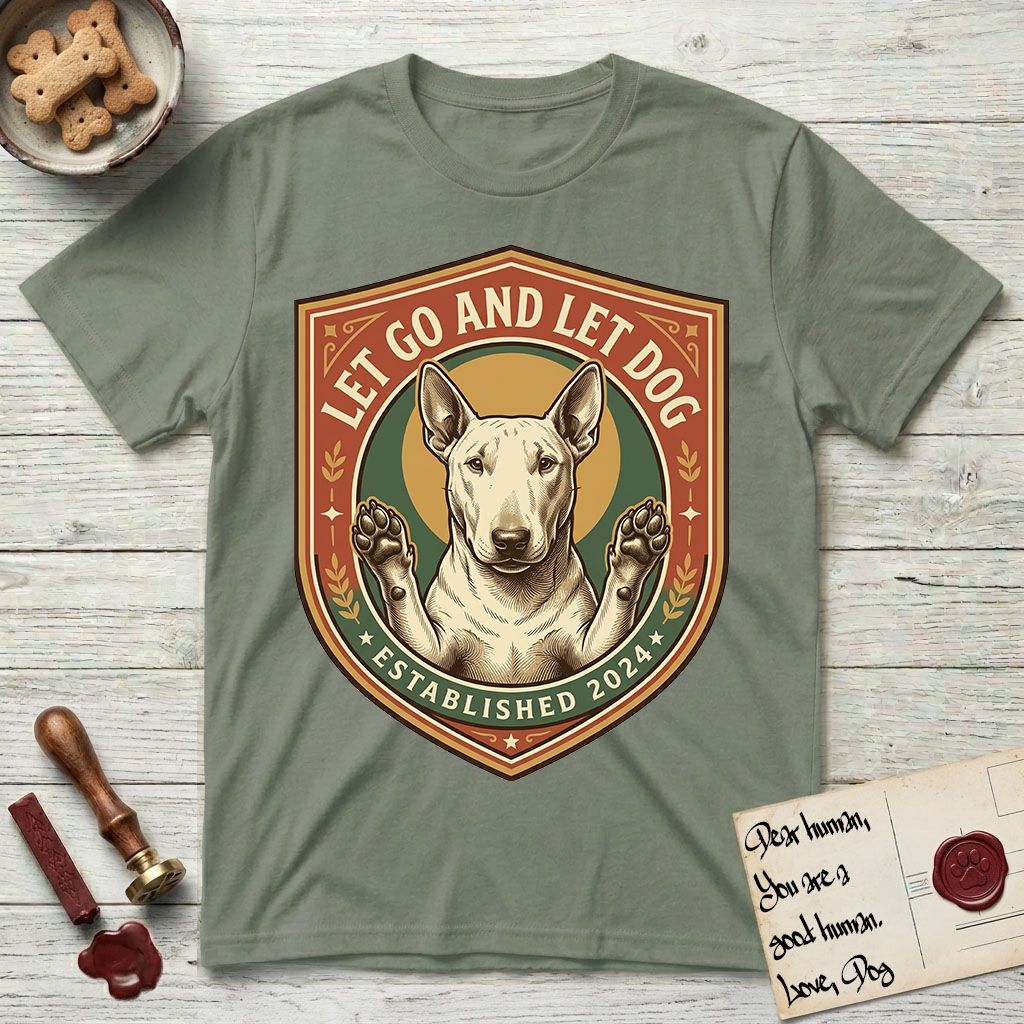 Let Go and Let Dog Bull Terrier T-Shirt flat lay in Sage, featuring a vintage badge of a haloed Bull Terrier with paws raised in blessing.