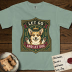 Let Go and Let Dog Corgi T-Shirt flat lay in Bay, featuring a royal heraldic shield badge of a crowned, haloed Corgi with paws raised.