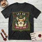 Let Go and Let Dog Corgi T-Shirt flat lay in Black, featuring a royal heraldic shield badge of a crowned, haloed Corgi with paws raised.