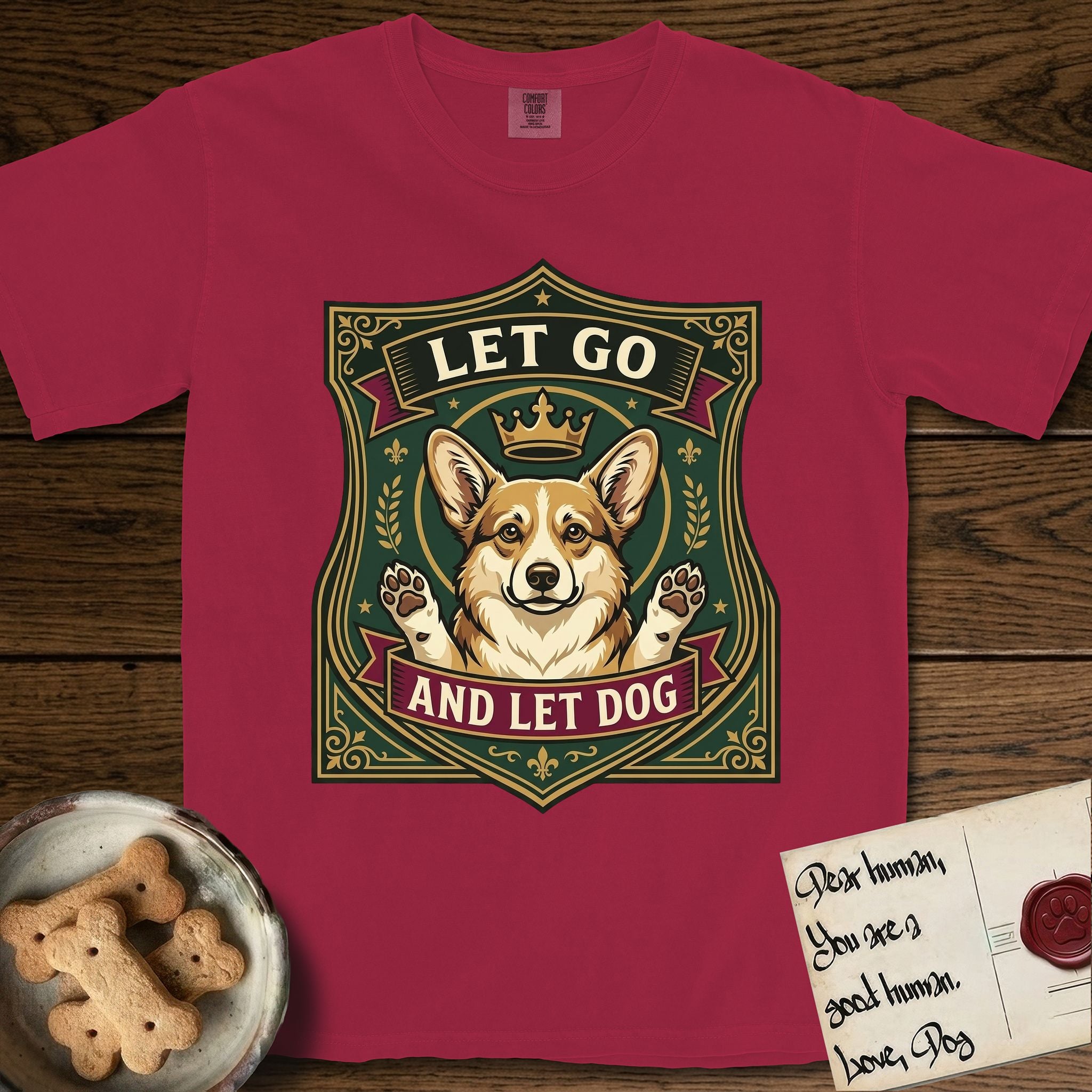 Let Go and Let Dog Corgi T-Shirt flat lay in Chili, featuring a royal heraldic shield badge of a crowned, haloed Corgi with paws raised.