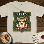Let Go and Let Dog Corgi T-Shirt flat lay in Ivory, featuring a royal heraldic shield badge of a crowned, haloed Corgi with paws raised.