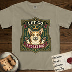 Let Go and Let Dog Corgi T-Shirt flat lay in Khaki, featuring a royal heraldic shield badge of a crowned, haloed Corgi with paws raised.