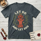 Let Go and Let Dog Dachshund T-Shirt flat lay in Dark Heather Grey, featuring a folk-art botanical illustration of a haloed Dachshund sitting up with front paws raised.