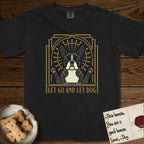 Let Go and Let Dog French Bulldog T-Shirt flat lay in Black, featuring an Art Deco arch with a haloed brindle French Bulldog, bat ears erect and paws raised, gold sunburst rays behind him.