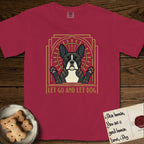 Let Go and Let Dog French Bulldog T-Shirt flat lay in Chili, featuring an Art Deco arch with a haloed brindle French Bulldog, bat ears erect and paws raised, gold sunburst rays behind him.