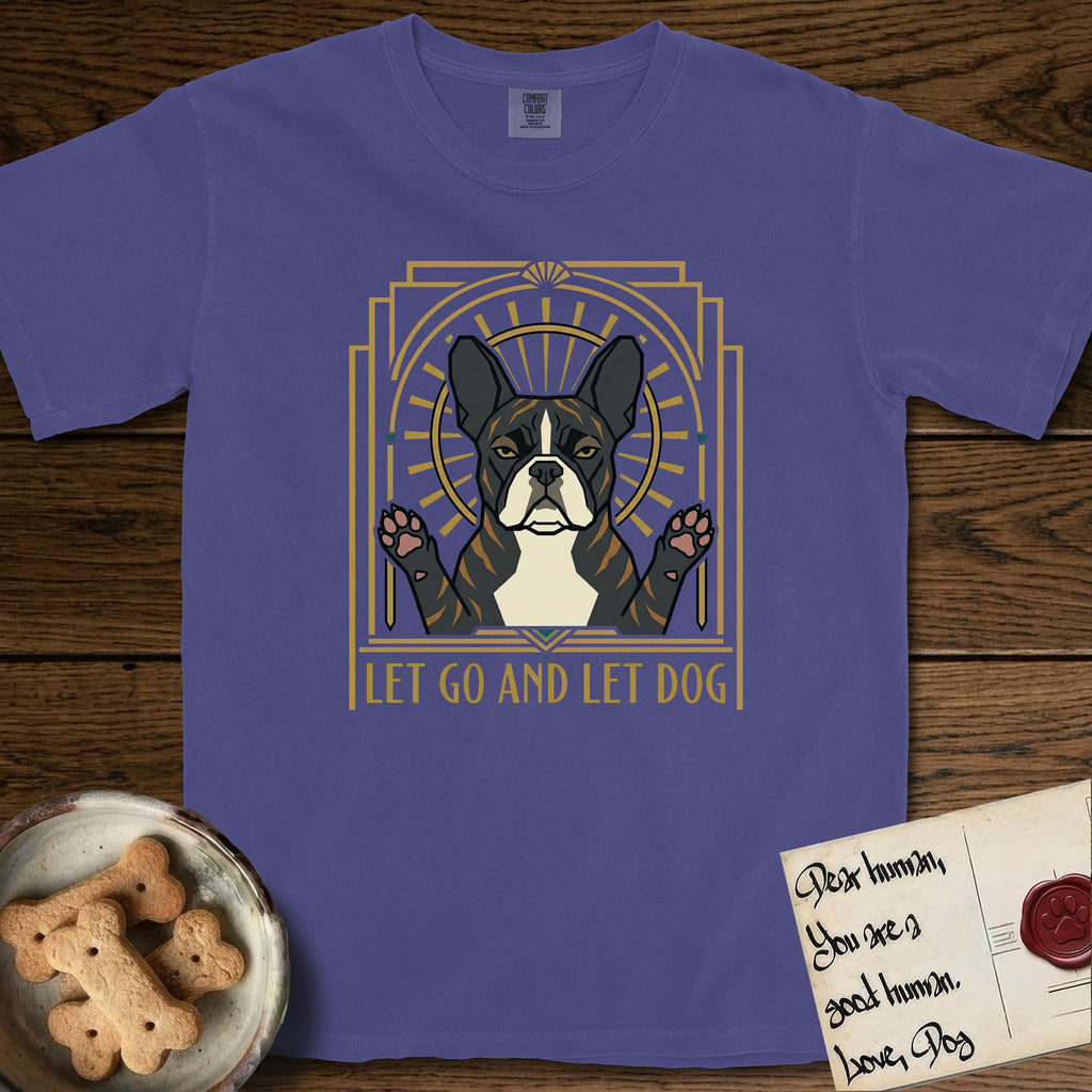 Let Go and Let Dog French Bulldog T-Shirt flat lay in Grape, featuring an Art Deco arch with a haloed brindle French Bulldog, bat ears erect and paws raised, gold sunburst rays behind him.