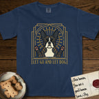 Let Go and Let Dog French Bulldog T-Shirt flat lay in True Navy, featuring an Art Deco arch with a haloed brindle French Bulldog, bat ears erect and paws raised, gold sunburst rays behind him.