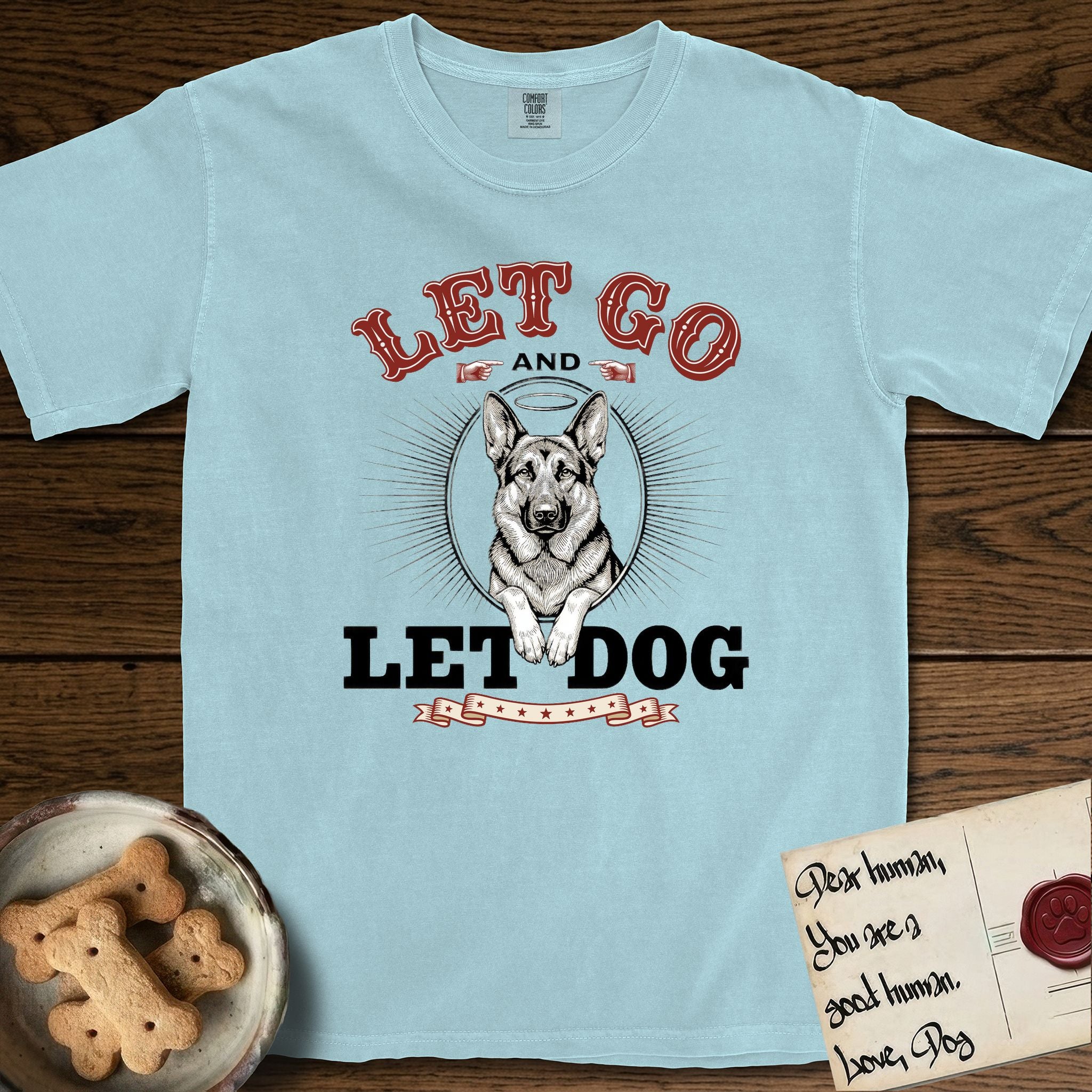 Let Go and Let Dog German Shepherd T-Shirt flat lay in Chambray, featuring a vintage letterpress engraving of a haloed German Shepherd framed by a sunburst oval.
