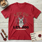 Let Go and Let Dog German Shepherd T-Shirt flat lay in Cherry Red, featuring a vintage letterpress engraving of a haloed German Shepherd framed by a sunburst oval.