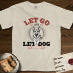 Let Go and Let Dog German Shepherd T-Shirt flat lay in Ivory, featuring a vintage letterpress engraving of a haloed German Shepherd framed by a sunburst oval.
