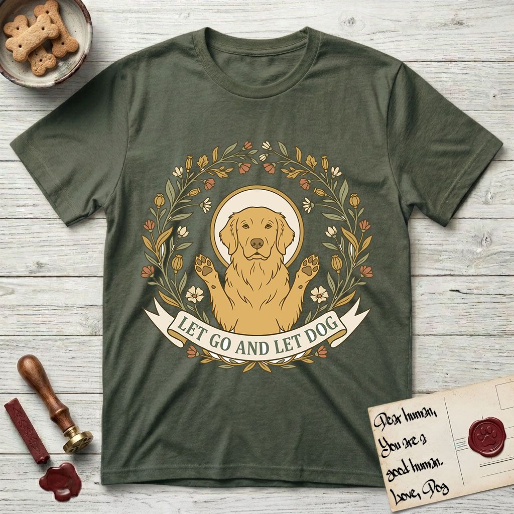Let Go and Let Dog Golden Retriever T-Shirt flat lay in Heather Military Green, featuring an Art Nouveau wildflower wreath around a haloed Golden Retriever with front paws raised.