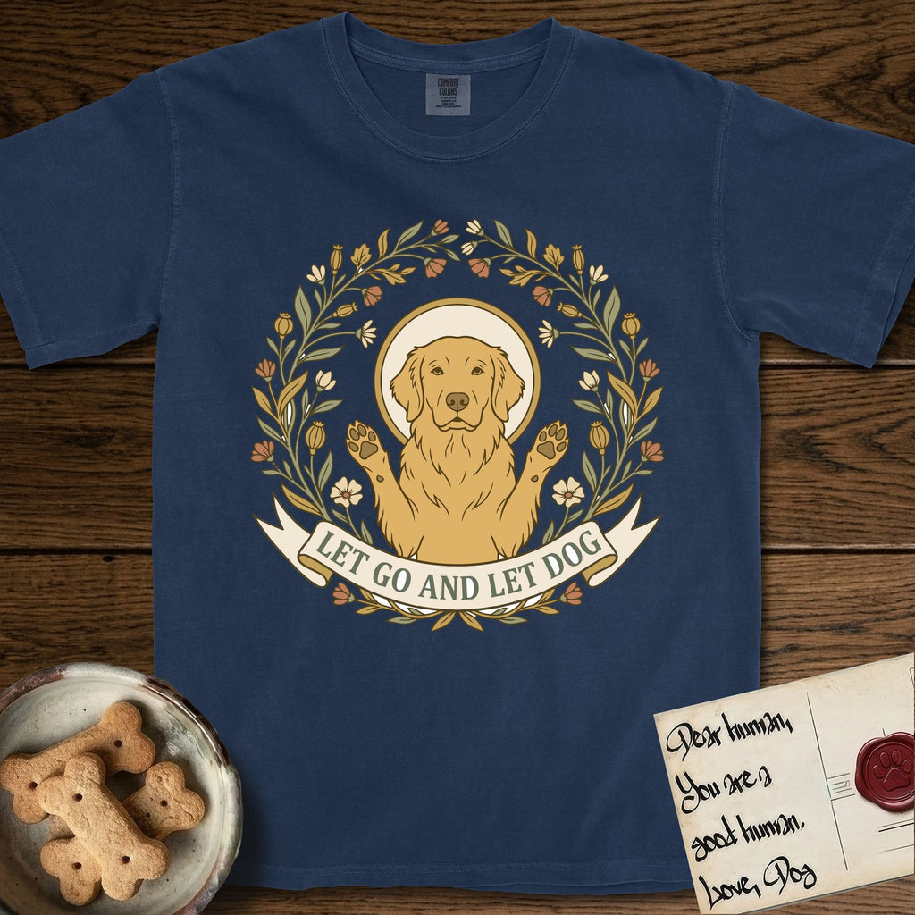Let Go and Let Dog Golden Retriever T-Shirt flat lay in True Navy, featuring an Art Nouveau wildflower wreath around a haloed Golden Retriever with front paws raised.