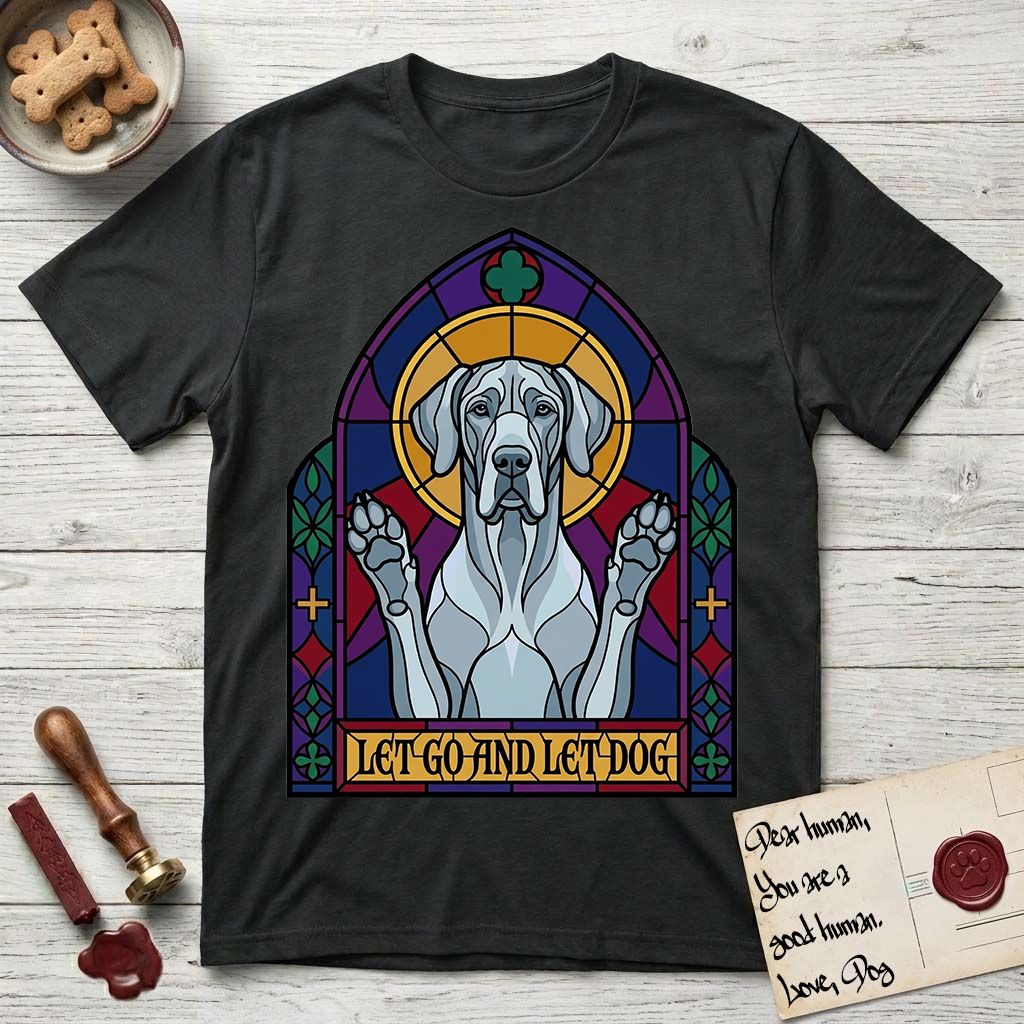 Let Go and Let Dog Great Dane T-Shirt flat lay in Black, featuring a stained-glass cathedral window of a haloed Great Dane with paws raised.