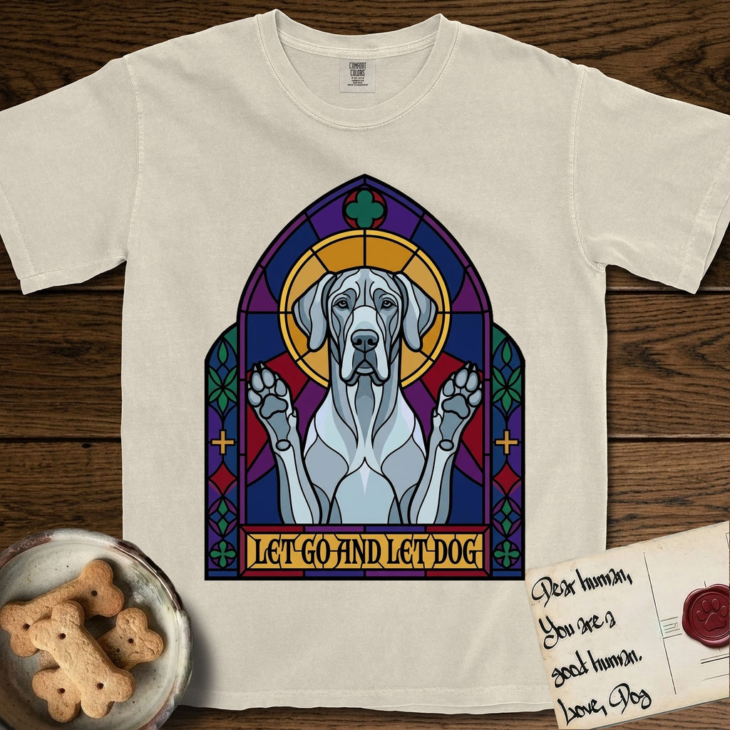 Let Go and Let Dog Great Dane T-Shirt flat lay in Ivory, featuring a stained-glass cathedral window of a haloed Great Dane with paws raised.