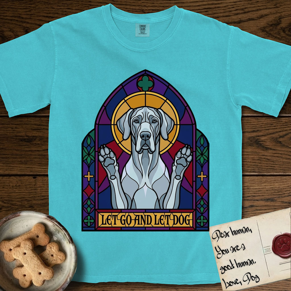 Let Go and Let Dog Great Dane T-Shirt flat lay in Lagoon Blue, featuring a stained-glass cathedral window of a haloed Great Dane with paws raised.