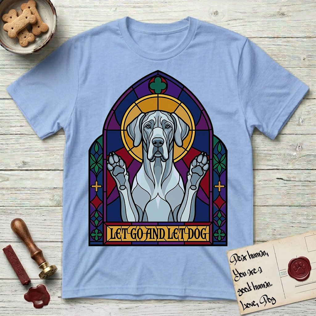 Let Go and Let Dog Great Dane T-Shirt flat lay in Light Blue, featuring a stained-glass cathedral window of a haloed Great Dane with paws raised.