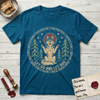 Let Go and Let Dog Husky T-Shirt flat lay in Antique Sapphire, featuring a winter woodland seal of a haloed Husky sitting with paws raised among pine trees.
