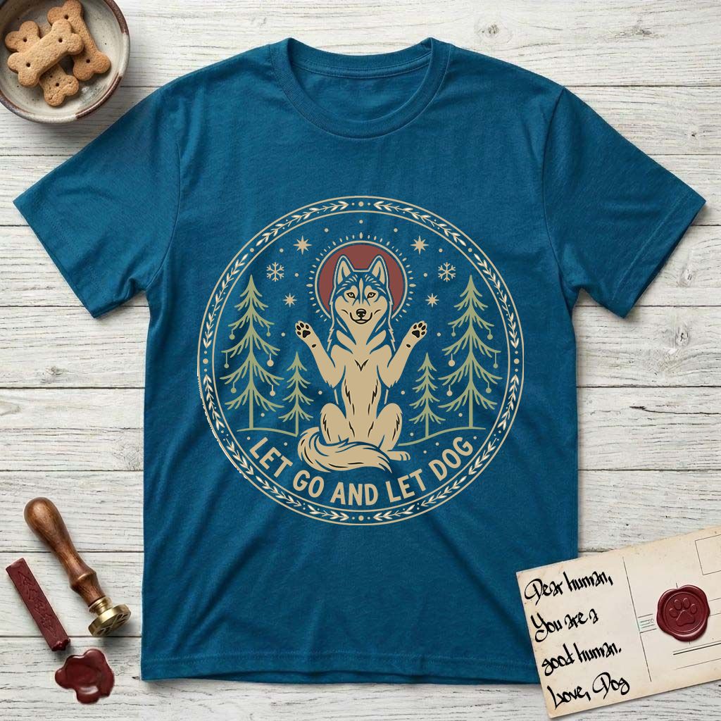 Let Go and Let Dog Husky T-Shirt flat lay in Antique Sapphire, featuring a winter woodland seal of a haloed Husky sitting with paws raised among pine trees.