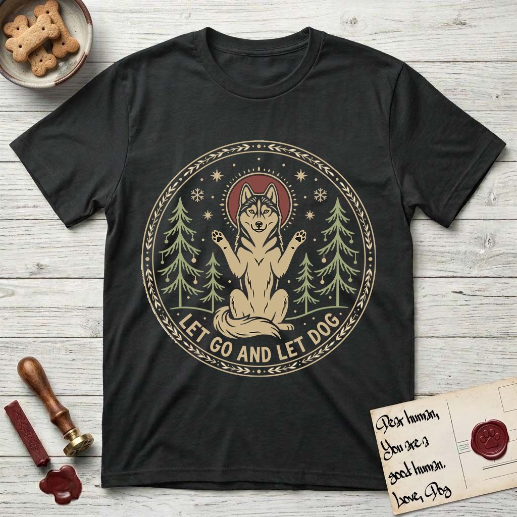 Let Go and Let Dog Husky T-Shirt flat lay in Black, featuring a winter woodland seal of a haloed Husky sitting with paws raised among pine trees.