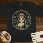 Let Go and Let Dog Husky T-Shirt flat lay in Black, featuring a winter woodland seal of a haloed Husky sitting with paws raised among pine trees.