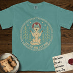 Let Go and Let Dog Husky T-Shirt flat lay in Blue Spruce, featuring a winter woodland seal of a haloed Husky sitting with paws raised among pine trees.