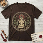 Let Go and Let Dog Husky T-Shirt flat lay in Dark Chocolate, featuring a winter woodland seal of a haloed Husky sitting with paws raised among pine trees.