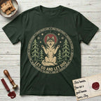 Let Go and Let Dog Husky T-Shirt flat lay in Forest Green, featuring a winter woodland seal of a haloed Husky sitting with paws raised among pine trees.