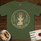 Let Go and Let Dog Husky T-Shirt flat lay in Hemp, featuring a winter woodland seal of a haloed Husky sitting with paws raised among pine trees.