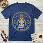 Let Go and Let Dog Husky T-Shirt flat lay in Royal, featuring a winter woodland seal of a haloed Husky sitting with paws raised among pine trees.