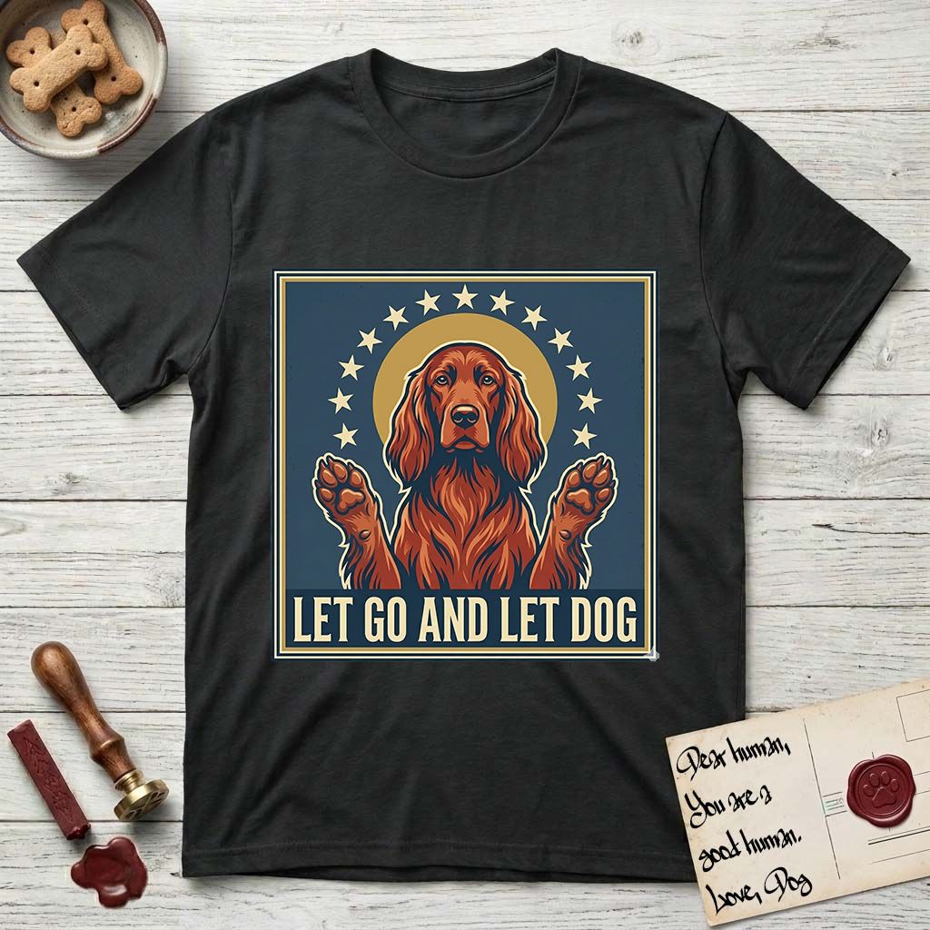 Let Go and Let Dog Irish Setter T-Shirt flat lay in Black, featuring a vintage devotional poster of a haloed Irish Setter with paws raised and a ring of stars.