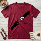 Let Go and Let Dog Paw T-Shirt flat lay in Antique Cherry Red, featuring a minimalist silhouette of a human hand and a Dog paw reaching toward each other, almost touching.