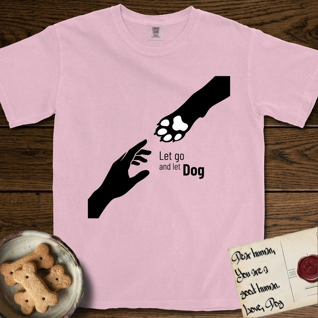 Let Go and Let Dog Paw T-Shirt flat lay in Blossom, featuring a minimalist silhouette of a human hand and a Dog paw reaching toward each other, almost touching.