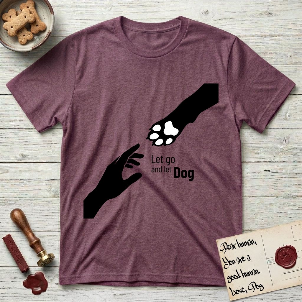 Let Go and Let Dog Paw T-Shirt flat lay in Heather Maroon, featuring a minimalist silhouette of a human hand and a Dog paw reaching toward each other, almost touching.