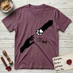 Let Go and Let Dog Paw T-Shirt flat lay in Heather Maroon, featuring a minimalist silhouette of a human hand and a Dog paw reaching toward each other, almost touching.