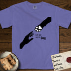 Let Go and Let Dog Paw T-Shirt flat lay in Violet, featuring a minimalist silhouette of a human hand and a Dog paw reaching toward each other, almost touching.