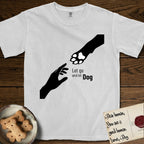 Let Go and Let Dog Paw T-Shirt flat lay in White, featuring a minimalist silhouette of a human hand and a Dog paw reaching toward each other, almost touching.