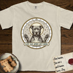 Let Go and Let Dog Pitbull T-Shirt flat lay in Ivory, featuring an antique engraved celestial star chart with a haloed Pitbull at the center, natural folded ears and paws raised, stars carved across his coat.