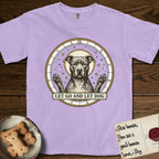 Let Go and Let Dog Pitbull T-Shirt flat lay in Orchid, featuring an antique engraved celestial star chart with a haloed Pitbull at the center, natural folded ears and paws raised, stars carved across his coat.
